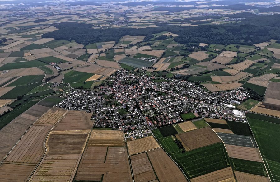 Aerial view of Besse, a district of Edermünde, with the wooded Langenberge behind it